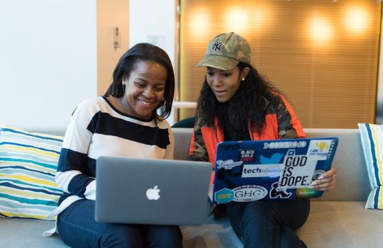 two-women-holding-laptop-1181273